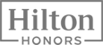 The image features the logo for Hilton Honors, with "Hilton" in a bold font and "Honors" written beneath it within a rectangular border.